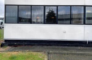 Clean cladding on same commercial building in Kent after soft washing treatment